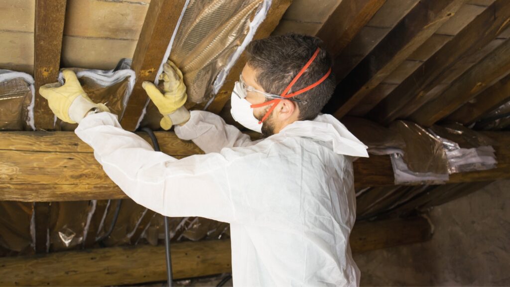 man installing insulation to a property